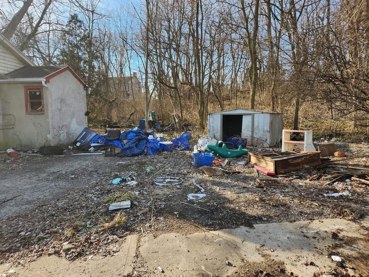 Before — trash strewn across a vacant lot