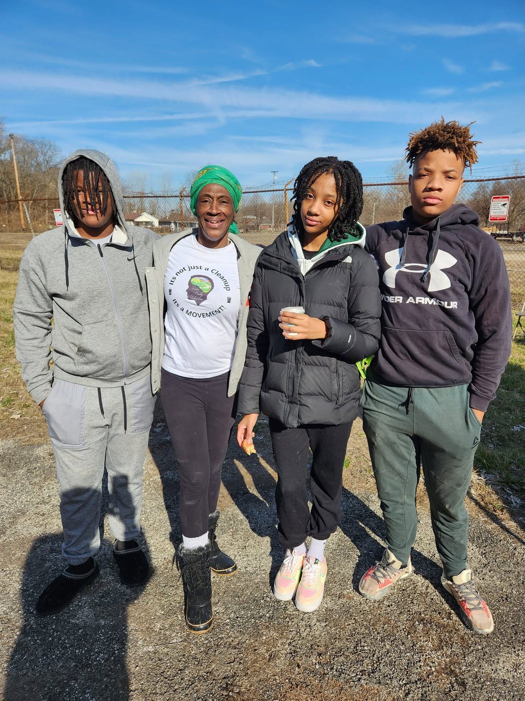 Four Liberty High School student volunteers standing together at a clean-up